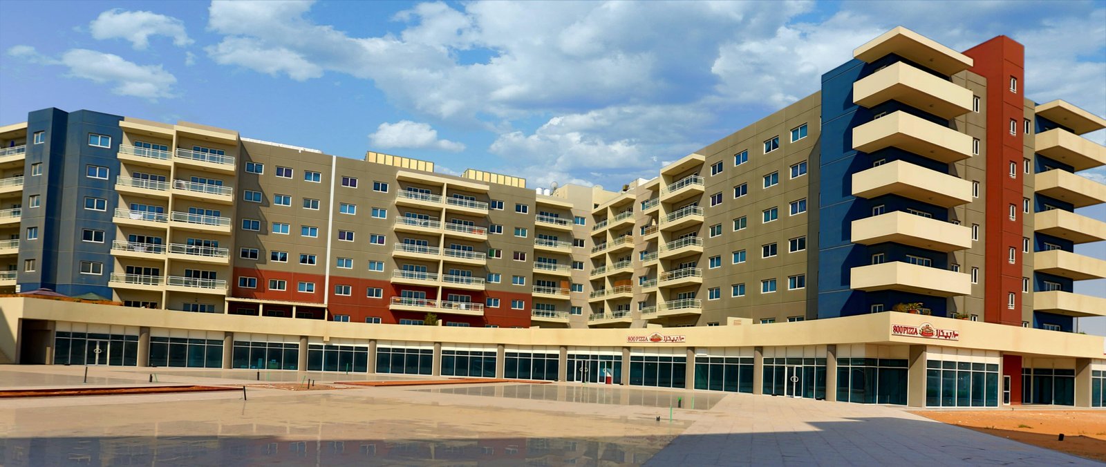 Landscaped courtyards and shaded outdoor spaces at Al Reef Downtown highlighting community-focused living and modern convenience.